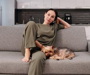 dog sitting on couch with you showing affection